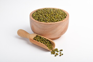 Mung beans in wooden bowl with wooden scoop isolated on white background.