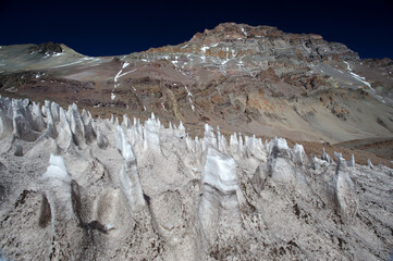 The enchanting beauty of the snowy mountains. The view of snow and rocks on the mountain tops.