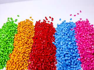 Colorful polymer plastic masterbatch pellets arranged by shade, showcasing high-quality additives used to enhance color, stability, and performance in plastic manufacturing processes efficiently