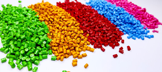 Colorful polymer plastic masterbatch pellets arranged by shade, showcasing high-quality additives used to enhance color, stability, and performance in plastic manufacturing processes efficiently
