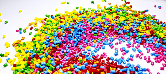 Colorful polymer plastic masterbatch pellets arranged by shade, showcasing high-quality additives used to enhance color, stability, and performance in plastic manufacturing processes efficiently.