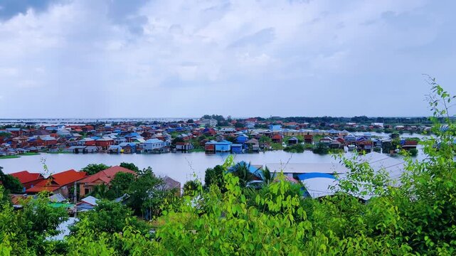 Viewpoint of a flooded fishing village near the Krahom Temple, Cambodia. From the mountain Krahom (Pnom Krom) overlooking the lake Tonlesap. Houses are built on high stilts. Rainy season. 4К