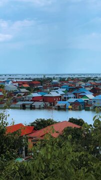 Viewpoint of a flooded fishing village near the Krahom Temple, Cambodia. From the mountain Krahom (Pnom Krom) overlooking the lake Tonlesap. Houses are built on high stilts. Rainy season. 4К