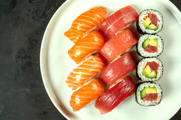 Assorted Sushi Platter with Fresh Salmon and Tuna Nigiri and Maki Rolls on White Plate