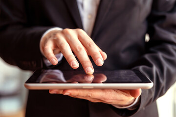 Businessperson Using Digital Tablet with Touchscreen Interface for Modern Mobile Technology Concept