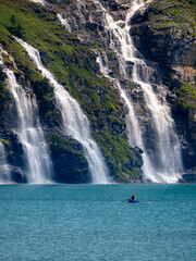 Rowboat on Turquoise Oeschinen Lake beneath Cascading Alpine Waterfalls, Bernese Oberland, Switzerland