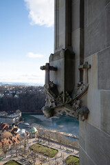 Gothic stone gargoyle on Bern Minster with Aare River and Old Town panorama, Switzerland © Carismarkus