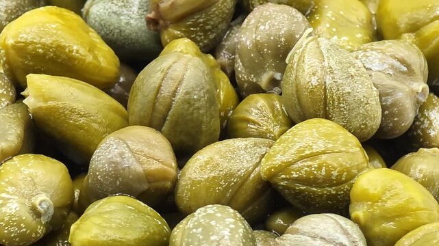 Pickled or salted capers close up. Delicious ingredients for cooking Mediterranean cuisine. Food macro