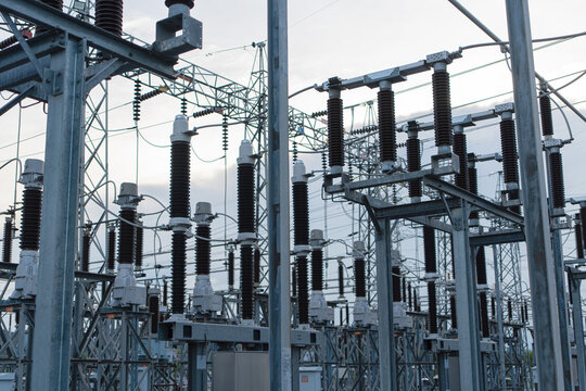 Industrial electrical equipment and high voltage insulators at a power substation. Infrastructure for energy distribution grid, electricity supply industry and engineering technology concepts.