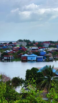 Viewpoint of a flooded fishing village near the Krahom Temple, Cambodia. From the mountain Krahom (Pnom Krom) overlooking the lake Tonlesap. Houses are built on high stilts. Rainy season. 4К