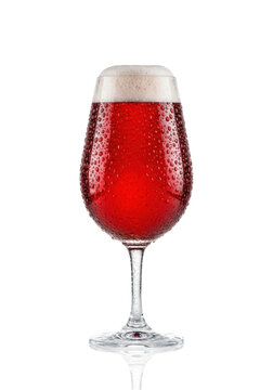 elegant stemmed glass of cold ruby red ale, thick creamy microfoam and intense condensation, dramatic rim lighting, isolated on a polished white reflective background. concept for beverage advertising