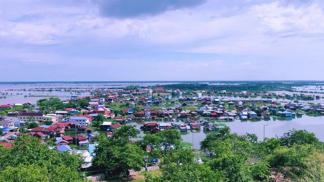 Viewpoint of a flooded fishing village near the Krahom Temple, Cambodia. From the mountain Krahom (Pnom Krom) overlooking the lake Tonlesap. Houses are built on high stilts. Rainy season. 4К