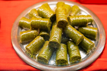 Extreme close-up of Turkish baklava with pistachios, showing flaky pastry layers and chopped nuts. Traditional dessert detail.

