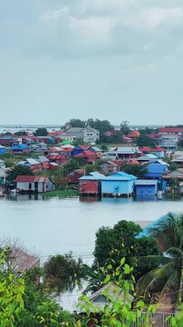 Viewpoint of a flooded fishing village near the Krahom Temple, Cambodia. From the mountain Krahom (Pnom Krom) overlooking the lake Tonlesap. Houses are built on high stilts. Rainy season. 4К