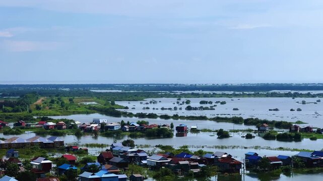 Viewpoint of a flooded fishing village near the Krahom Temple, Cambodia. From the mountain Krahom (Pnom Krom) overlooking the lake Tonlesap. Houses are built on high stilts. Rainy season. 4К