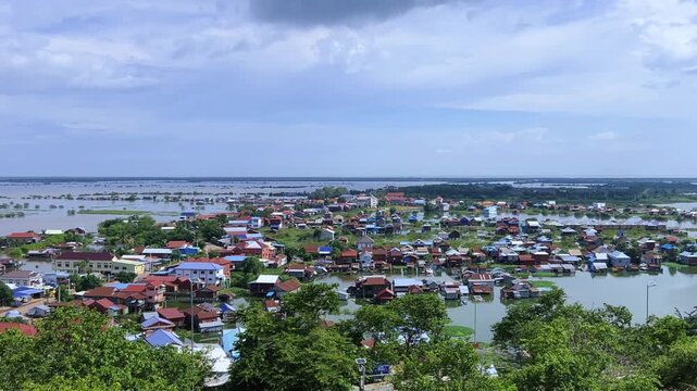 Viewpoint of a flooded fishing village near the Krahom Temple, Cambodia. From the mountain Krahom (Pnom Krom) overlooking the lake Tonlesap. Houses are built on high stilts. Rainy season. 4К