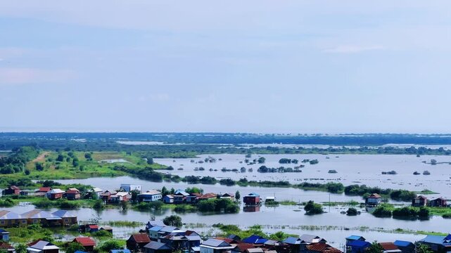 Viewpoint of a flooded fishing village near the Krahom Temple, Cambodia. From the mountain Krahom (Pnom Krom) overlooking the lake Tonlesap. Houses are built on high stilts. Rainy season. 4К