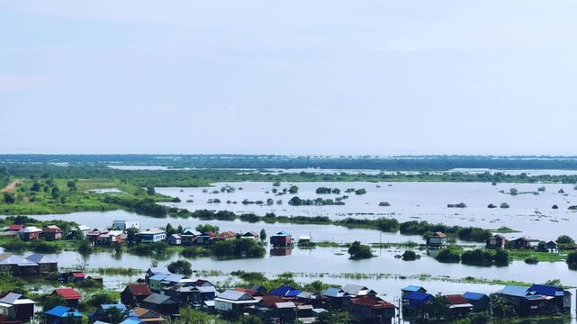 Viewpoint of a flooded fishing village near the Krahom Temple, Cambodia. From the mountain Krahom (Pnom Krom) overlooking the lake Tonlesap. Houses are built on high stilts. Rainy season. 4К