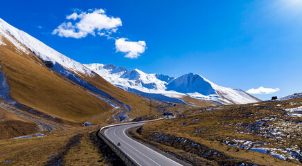 Aerial view of Winding Mountain Road with Snow-Capped Peaks in Road Through the Great Caucasus ,Georgia