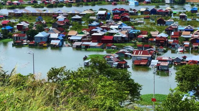 Viewpoint of a flooded fishing village near the Krahom Temple, Cambodia. From the mountain Krahom (Pnom Krom) overlooking the lake Tonlesap. Houses are built on high stilts. Rainy season. 4К