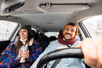 Couple travelling to winter vacation by car