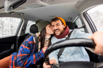 Couple travelling to winter vacation by car