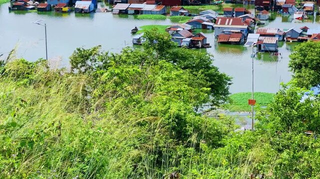 Viewpoint of a flooded fishing village near the Krahom Temple, Cambodia. From the mountain Krahom (Pnom Krom) overlooking the lake Tonlesap. Houses are built on high stilts. Rainy season. 4К