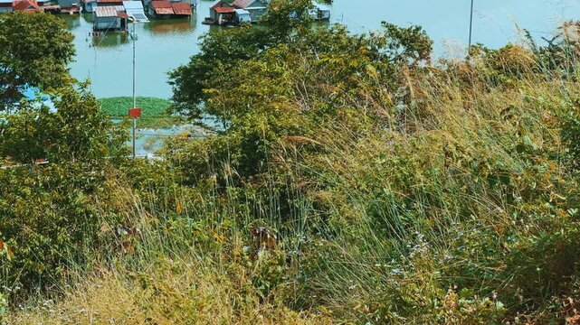 Viewpoint of a flooded fishing village near the Krahom Temple, Cambodia. From the mountain Krahom (Pnom Krom) overlooking the lake Tonlesap. Houses are built on high stilts. Rainy season. 4К