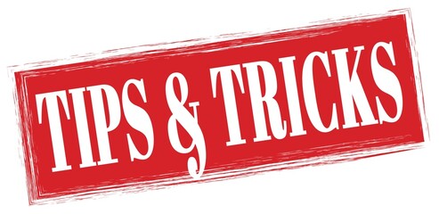 TIPS & TRICKS text written on red stamp sign.