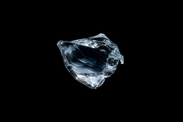 Transparent ice chunk isolated on black background closeup abstract clean cool cold crystal design element detail frozen frost glistening light natural object purity refreshing texture water