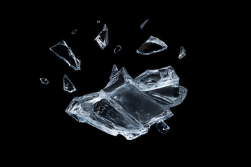Many transparent shards of broken glass on black background isolated abstract shapes clear texture elements for design with reflection and refraction light