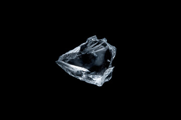 bent shard of transparent glass, delicate curves and sharp fractured lines, isolated on black, studio lighting emphasizing form and texture, represents breakable object, fragility, abstract element