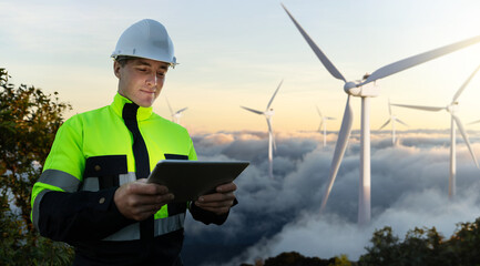 Engineer using tablet at wind farm for clean energy and carbon credit monitoring