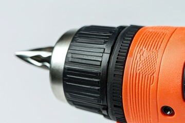 A close-up of an orange-black electric hand drill against a white background, used in hardware advertising