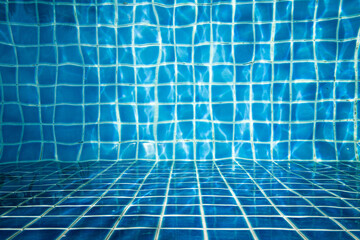 Abstract scene of moving water sprite under the water surface with blue square tiles background.