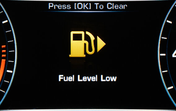 Low Fuel. A car s gas gauge showing low on fuel.  Sensor fuel warning on digital dashboard. Low fuel level.