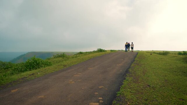 Three Young Friends Jumping with Joy at Sunset near Atal Tunnel on the Leh&ndash;Manali Highway, Himalayas, India