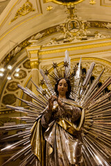 Radiant Virgin Mary Statue With Starburst Halo In Ornate Gold Cathedral Interior