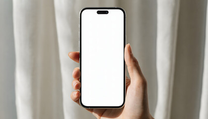 Hand holding a smartphone with a white screen in front of a curtain