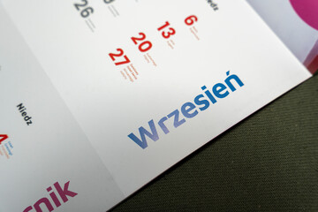 Handwritten text 'Wrzesień' on a white calendar page displays the month of September. Ideal for seasonal themes, planning content, or illustrating a time frame in design projects.