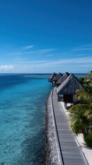 Obraz premium Breathtaking Vertical Shot of Overwater Bungalows Stretching into Crystal Clear Ocean