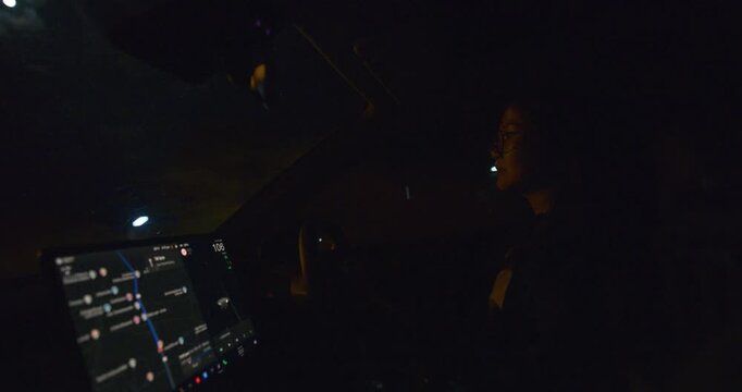 Business woman drive car navigator at night transport technology