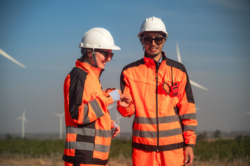 Japanese male wind turbine engineer and female technician working together in wind turbine field