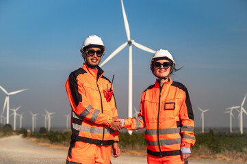 Japanese male wind turbine engineer and female technician working together in wind turbine field