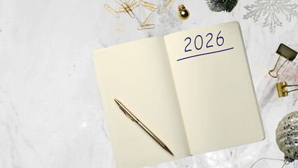 Vintage quill feather and ink pot resting on an antique blank notebook over an old wooden desk for business education and retro writing message