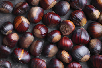Fresh chestnuts filling the frame with rich brown textures in a natural autumn food background