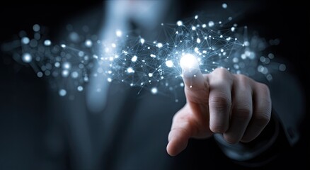 Hand touching illuminated digital network, signifying connectivity and data
