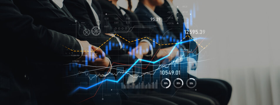 A group of professionals engaged in a business meeting, analyzing financial data displayed through digital graphs and charts in a modern office environment. Scalp - Powered by Adobe