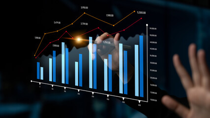 A business professional interacts with financial charts in a modern office setting. The scene captures the essence of data analysis and decision-making for business success. Scalp