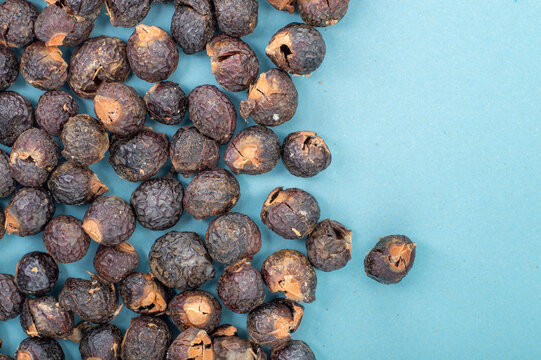 Soap nuts scattered in top view with copy space. Natural detergent background for eco friendly zero waste laundry and household cleaning, ideal for packaging, branding, and wellness designs.